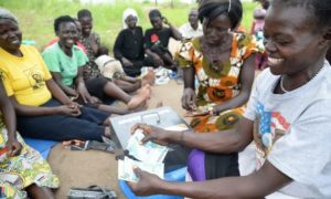 Photo: Members of a women savings group count the money raised in one seating. ©2018 World Vision, Moses Mukitale.