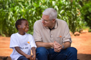 Rich Stearns talks with Leonard, a 10-year-old boy who is his HIV+ widowed mother's last hope for care. He will be by her side when she dies. She thinks it will be soon. Tests show Margret Maleka, 35, has AIDS. Leonard Songolo (sponsored) and his mother will receive a new house from the ADP, and were visited by WVUS President Rich Stearns and his wife, Renee. (Photo: Jon Warren, 2004)