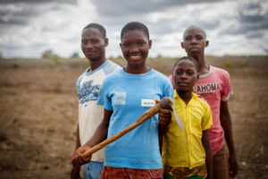 Photo: From left, Dennis, 26, Harusi, 14, Neema, 11, and James, 16. Neema lives in Marafa, Kenya, with eight siblings and her parents. They struggled for years with the side effects of drinking unsafe water from the swamp near their home. Everything changed in 2011, when World Vision drilled a deep borehole well in Marafa. By August 2013, it served 5,000 people.  © 2015 World Vision, Chris Huber