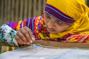 Woman does embroidery in Bangladesh