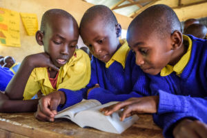 kids reading the Bible in Kenya