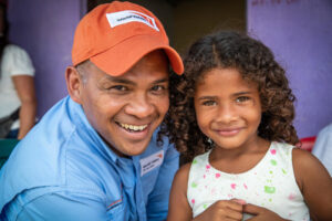 World Vision staff with young girl in Colombia