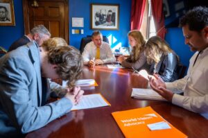 World Vision Youth Advocates pray with their congressman.